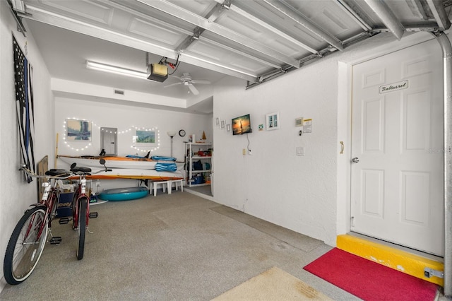 garage with a garage door opener and electric panel