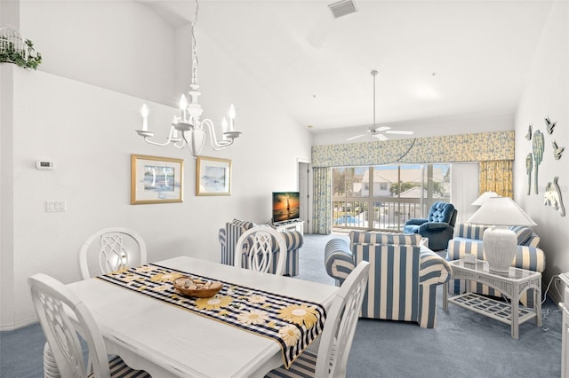 carpeted dining space featuring ceiling fan with notable chandelier