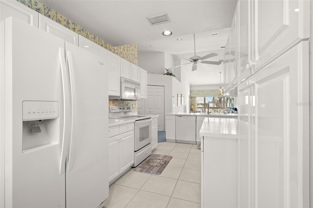 kitchen with ceiling fan, light tile patterned floors, white cabinets, and white appliances