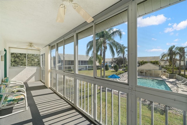 sunroom with a healthy amount of sunlight and ceiling fan