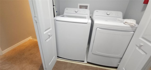 laundry room with light carpet and washing machine and clothes dryer