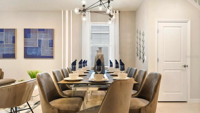 dining space featuring light tile patterned flooring and a notable chandelier