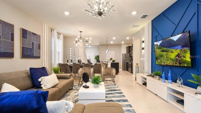 tiled living room with a notable chandelier