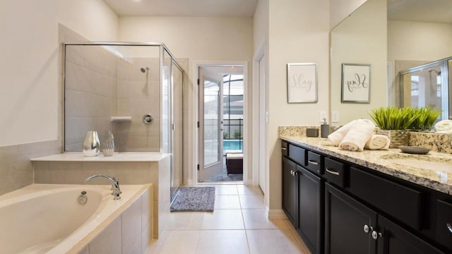 bathroom with vanity, independent shower and bath, and tile patterned flooring