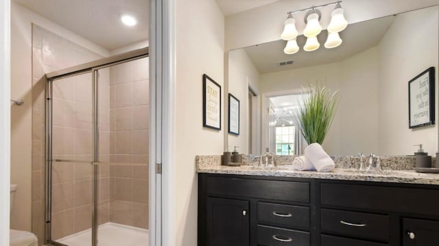 bathroom with vanity, toilet, and walk in shower