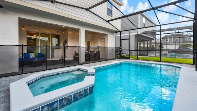 view of swimming pool with an in ground hot tub, a lanai, and a patio