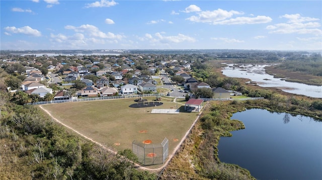 drone / aerial view with a water view and a residential view