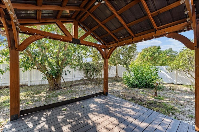 wooden terrace with a fenced backyard