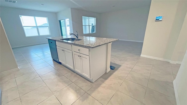 kitchen with sink, light stone counters, dishwashing machine, a kitchen island with sink, and white cabinets