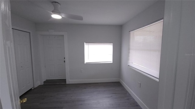 unfurnished room with ceiling fan, baseboards, and wood finished floors