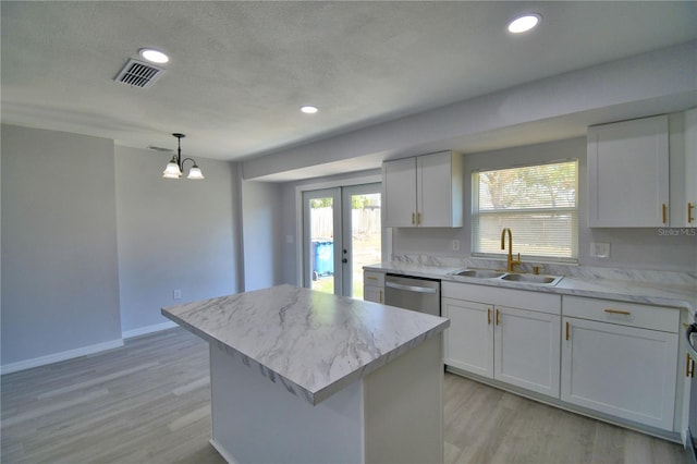 kitchen with a kitchen island, decorative light fixtures, dishwasher, sink, and white cabinets