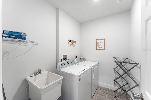 laundry room featuring sink and washing machine and clothes dryer