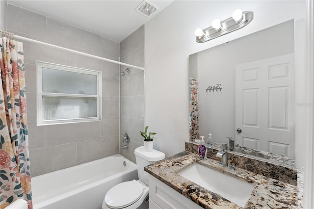 full bathroom with vanity, shower / tub combo with curtain, and toilet