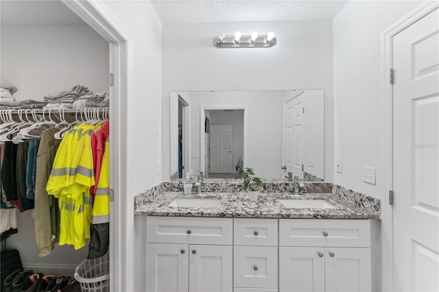 bathroom featuring vanity and a textured ceiling