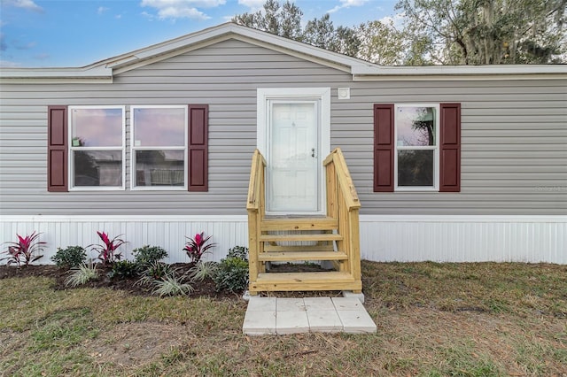 doorway to property with a yard