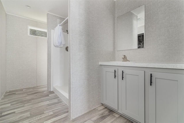 bathroom featuring vanity, curtained shower, and wood-type flooring