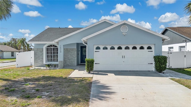 single story home featuring a garage and a front yard