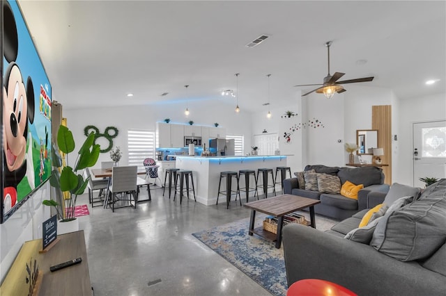 living room featuring lofted ceiling, concrete floors, and ceiling fan