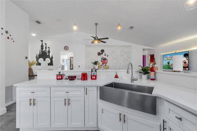 kitchen with decorative light fixtures, white cabinetry, lofted ceiling, sink, and ceiling fan