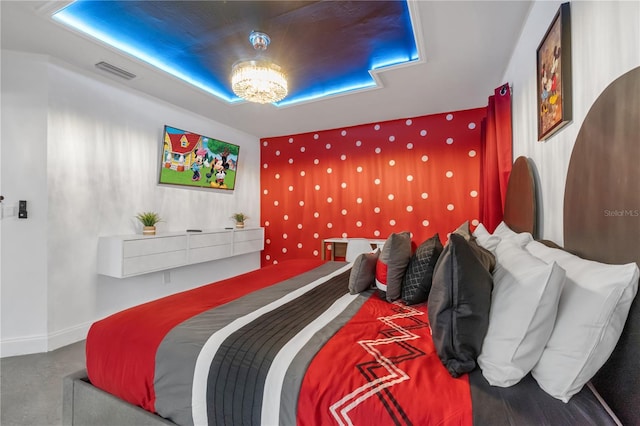 bedroom featuring a notable chandelier and a raised ceiling