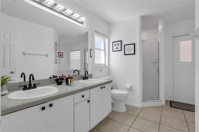 bathroom featuring walk in shower, vanity, toilet, and tile patterned flooring