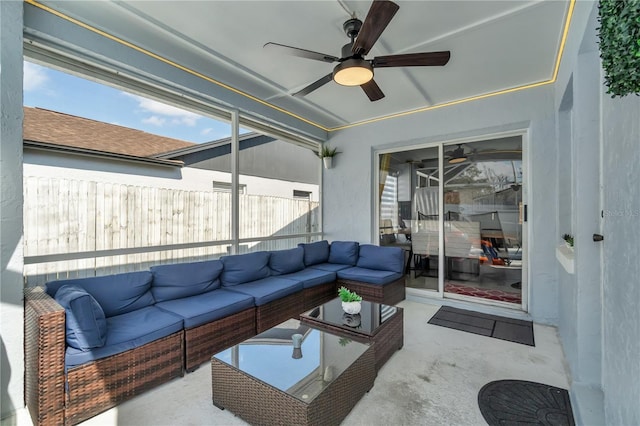 sunroom featuring ceiling fan