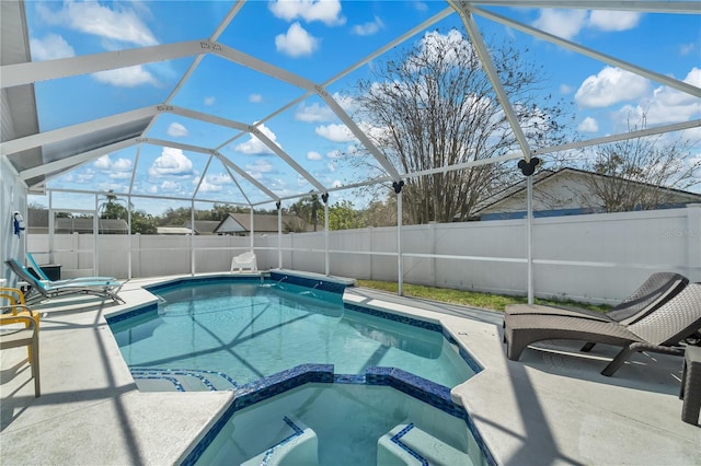 view of pool with an in ground hot tub, a lanai, and a patio area