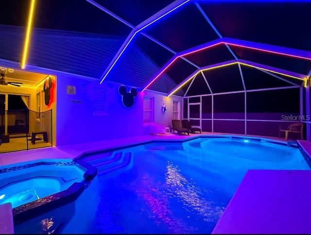 view of swimming pool with a patio area, glass enclosure, and an in ground hot tub