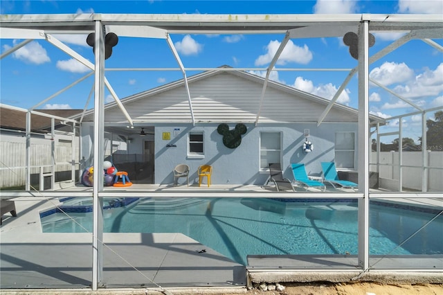 view of swimming pool featuring a lanai, a patio area, and ceiling fan