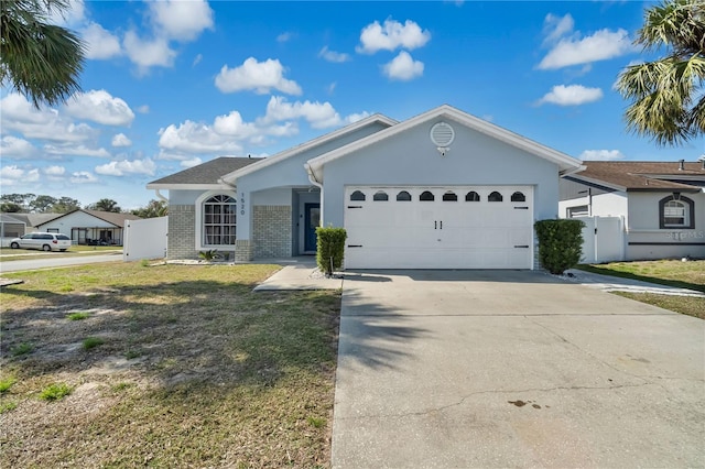 single story home featuring a garage and a front yard