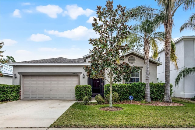 view of front of home featuring a garage and a front yard