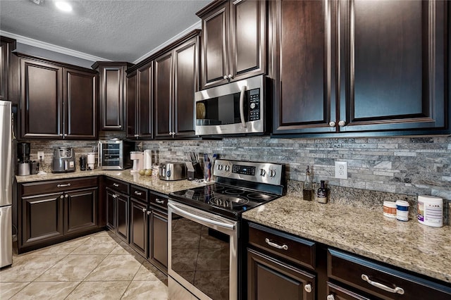 kitchen featuring appliances with stainless steel finishes, backsplash, dark brown cabinets, light stone counters, and a textured ceiling