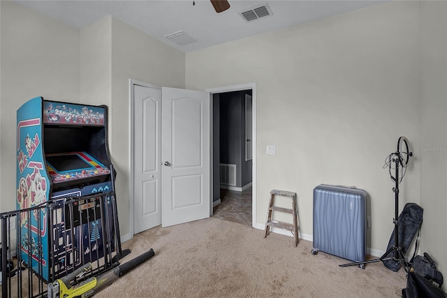 interior space featuring light colored carpet and ceiling fan