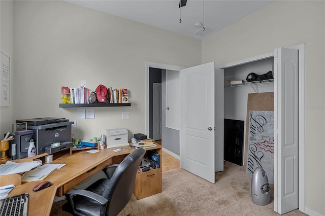 home office featuring ceiling fan and light carpet