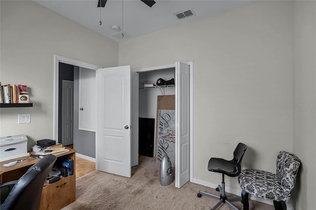 carpeted home office with ceiling fan