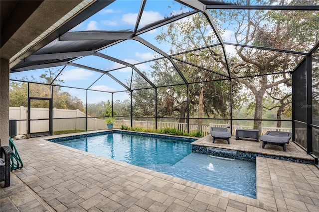 view of swimming pool featuring a patio, a lanai, and pool water feature