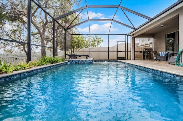 view of pool featuring area for grilling, glass enclosure, and a patio area