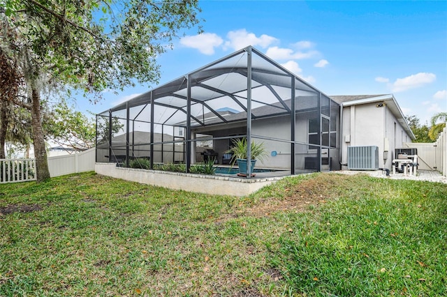 back of property featuring cooling unit, a lanai, a lawn, and a patio