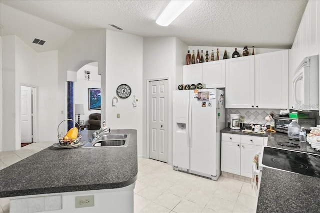 kitchen featuring white cabinetry, sink, white appliances, and decorative backsplash