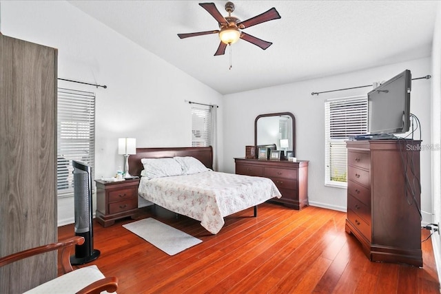 bedroom with vaulted ceiling, hardwood / wood-style floors, and ceiling fan