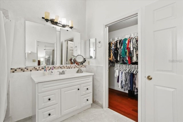 bathroom with vanity, tile walls, and tile patterned floors