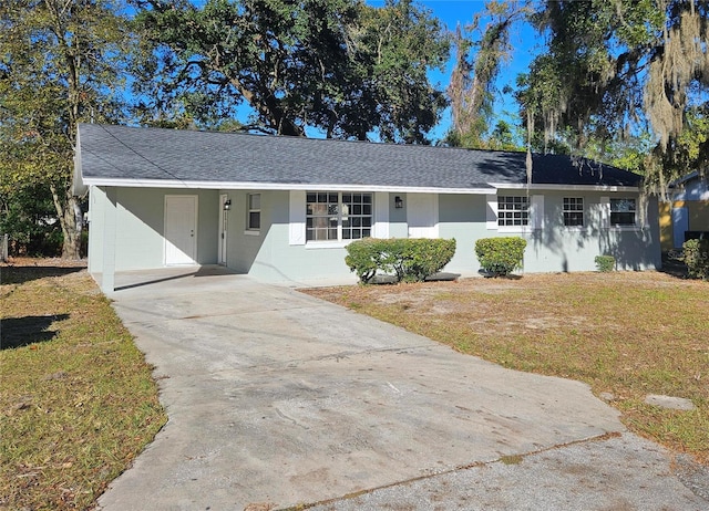 single story home featuring a front yard and a carport