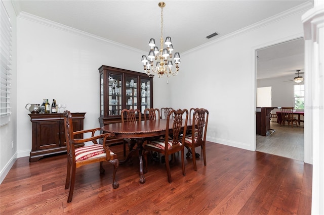 dining space with ornamental molding, dark hardwood / wood-style floors, and ceiling fan with notable chandelier