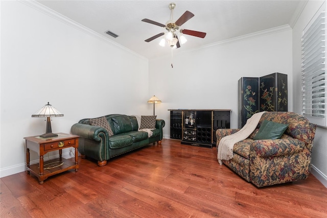 living room featuring crown molding, hardwood / wood-style floors, and ceiling fan