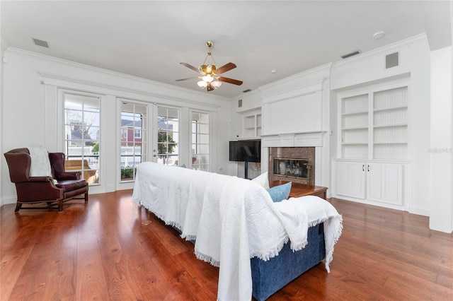 living room with dark hardwood / wood-style flooring, crown molding, a high end fireplace, and french doors