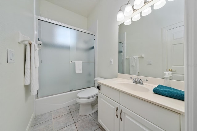 full bathroom featuring vanity, tile patterned floors, shower / bath combination with glass door, and toilet