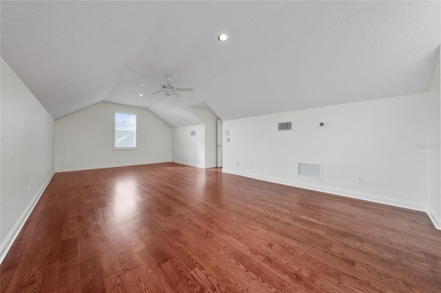 bonus room featuring lofted ceiling, hardwood / wood-style floors, and ceiling fan