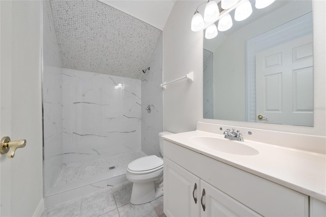 bathroom featuring vanity, toilet, and tiled shower