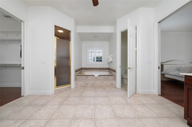 bathroom with ceiling fan, tile patterned floors, toilet, and separate shower and tub