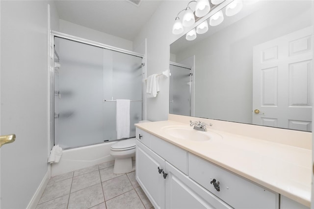 full bathroom featuring toilet, vanity, bath / shower combo with glass door, and tile patterned flooring